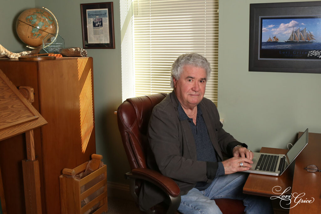 A man sitting in front of a laptop computer.